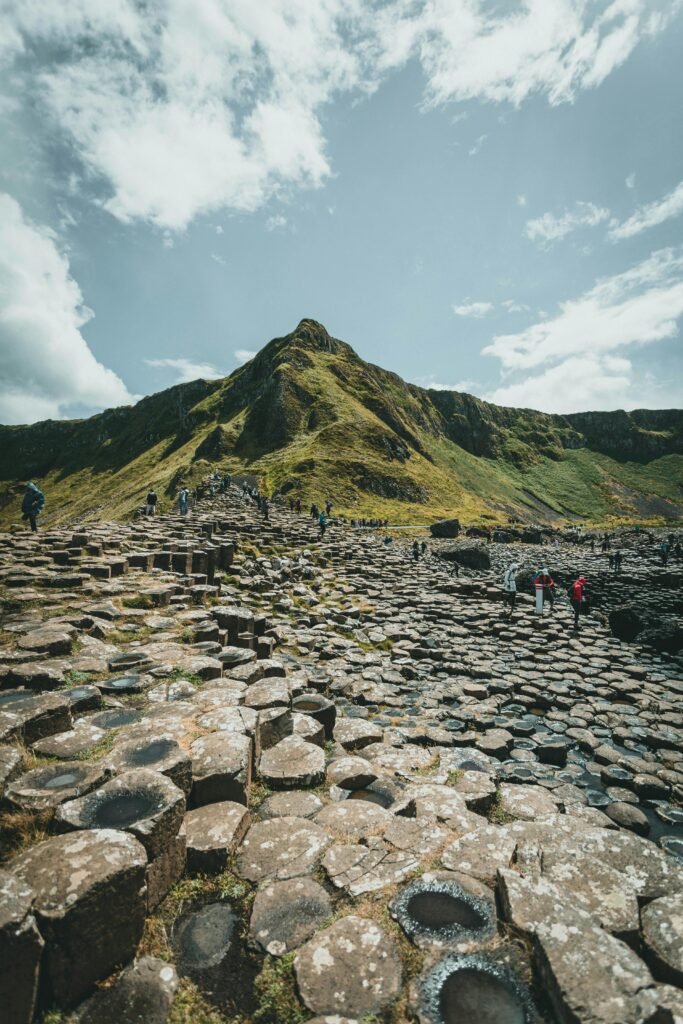 pexels-photo-8811506-8811506 Capture of people hiking among basalt columns at Giant's Causeway.